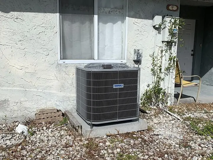 Replacement condenser on a landscaped bed