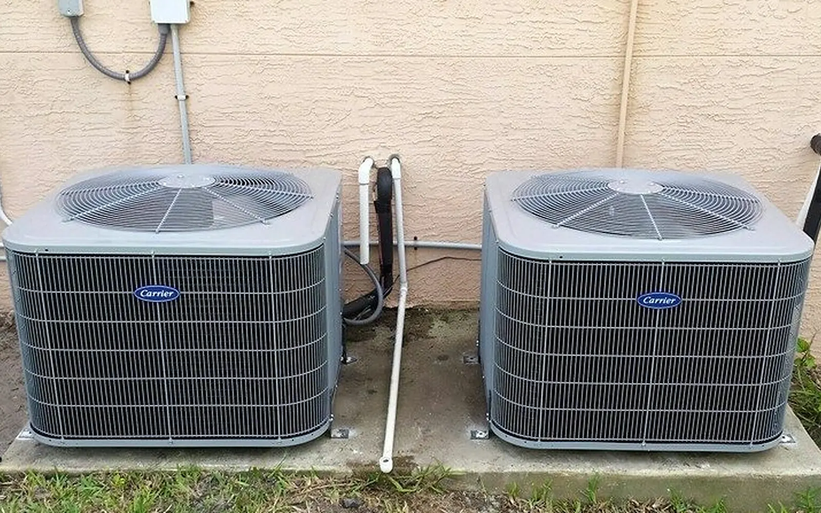 Two new condensers installed side by side at a home
