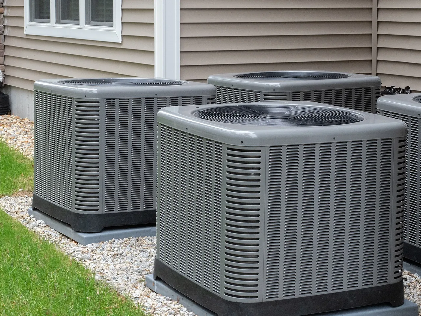 New air conditioning condensers installed on a lawn beside a Florida home