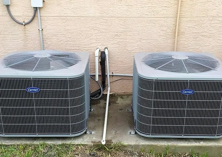 Two new condensers installed side by side at a home